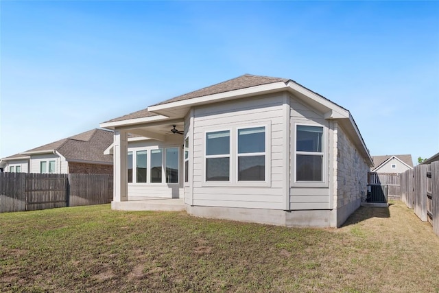 105 Lemuel Crawford Trl, Bastrop, TX 78602 - back of house with a fenced backyard, a ceiling fan, a lawn, a patio area, and central AC unit