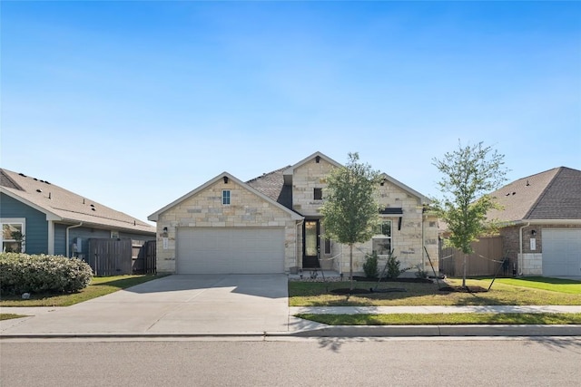 105 Lemuel Crawford Trl, Bastrop, TX 78602 - view of front facade featuring a garage, driveway, stone siding, and fence