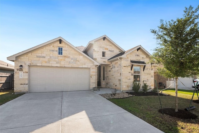 105 Lemuel Crawford Trl, Bastrop, TX 78602 - view of front of property with driveway, a garage, stone siding, and a front yard