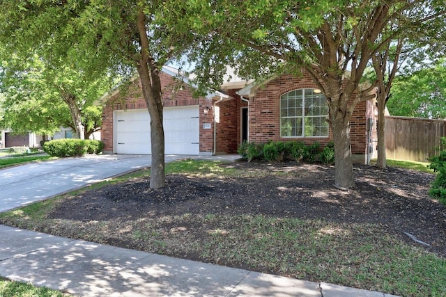 806 Broken Trace Ct, Round Rock, TX 78665 - view of property hidden behind natural elements featuring brick siding, an attached garage, and concrete driveway