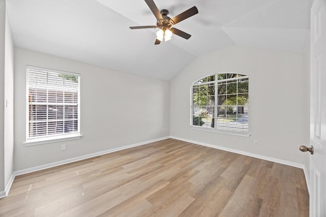 806 Broken Trace Ct, Round Rock, TX 78665 - empty room with plenty of natural light, wood finished floors, ceiling fan, vaulted ceiling, and baseboards
