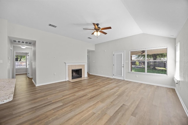 806 Broken Trace Ct, Round Rock, TX 78665 - unfurnished living room with ceiling fan, light wood-type flooring, a fireplace, lofted ceiling, and baseboards