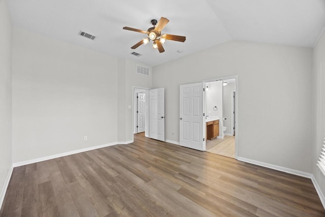 806 Broken Trace Ct, Round Rock, TX 78665 - unfurnished bedroom with light wood-style floors, vaulted ceiling, baseboards, ensuite bath, and a ceiling fan