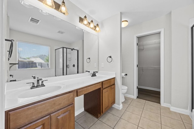 806 Broken Trace Ct, Round Rock, TX 78665 - full bath with a stall shower, toilet, a walk in closet, double vanity, and tile patterned floors