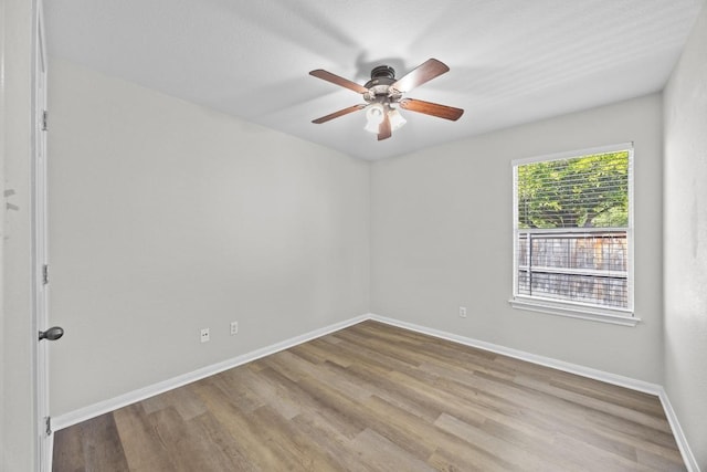 806 Broken Trace Ct, Round Rock, TX 78665 - empty room with wood finished floors, baseboards, and a ceiling fan