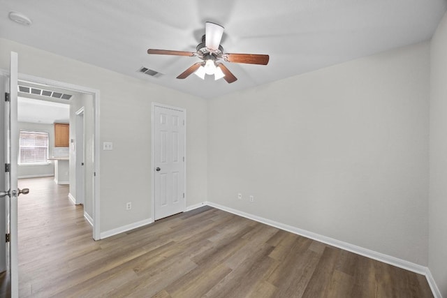 806 Broken Trace Ct, Round Rock, TX 78665 - unfurnished bedroom featuring wood finished floors, baseboards, and a ceiling fan