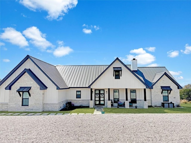 468 Cedar Mountain Dr, Marble Falls, TX 78654 - modern inspired farmhouse with board and batten siding, a chimney, a metal roof, and stone siding