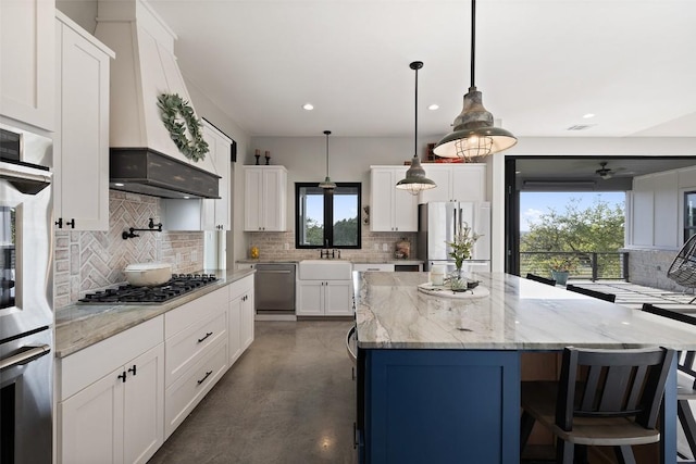 468 Cedar Mountain Dr, Marble Falls, TX 78654 - kitchen with stainless steel appliances, tasteful backsplash, finished concrete flooring, a center island, and white cabinets