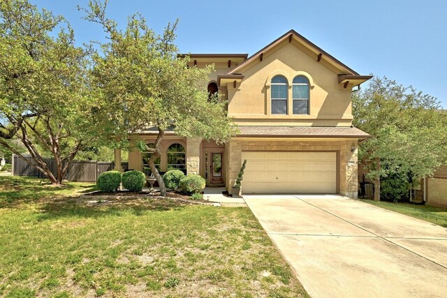 21940 Agarito Ln, Spicewood, TX 78669 - view of front facade with stone siding, an attached garage, concrete driveway, and stucco siding