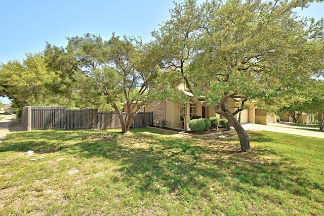 21940 Agarito Ln, Spicewood, TX 78669 - view of yard featuring concrete driveway and a garage