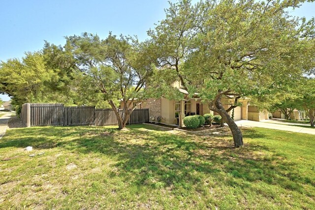 21940 Agarito Ln, Spicewood, TX 78669 - view of yard with driveway and a garage
