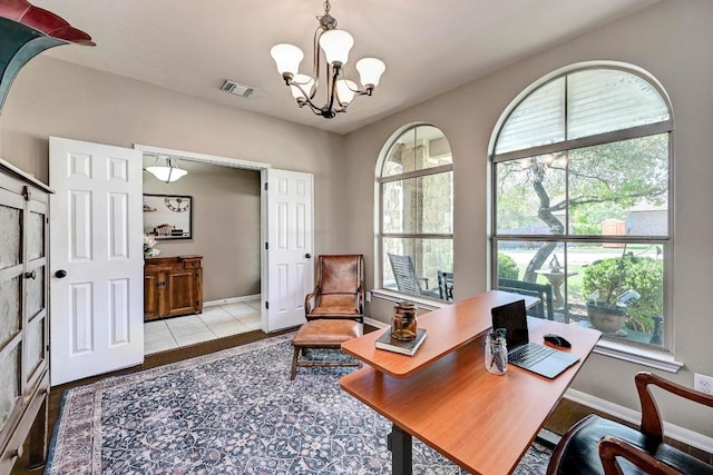 21940 Agarito Ln, Spicewood, TX 78669 - office space with healthy amount of natural light, a chandelier, and baseboards