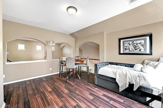 21940 Agarito Ln, Spicewood, TX 78669 - bedroom with wood finished floors, baseboards, and arched walkways