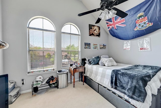 21940 Agarito Ln, Spicewood, TX 78669 - carpeted bedroom featuring vaulted ceiling, multiple windows, baseboards, and ceiling fan