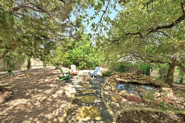 21940 Agarito Ln, Spicewood, TX 78669 - view of yard featuring an outdoor fire pit and a patio area