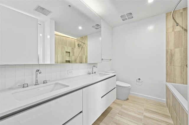 313 W 17th St Unit 2403, Austin, TX 78701 - bathroom with a sink, visible vents, and recessed lighting