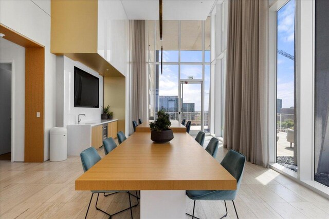 313 W 17th St Unit 2403, Austin, TX 78701 - dining space with light tile patterned flooring, a towering ceiling, and floor to ceiling windows