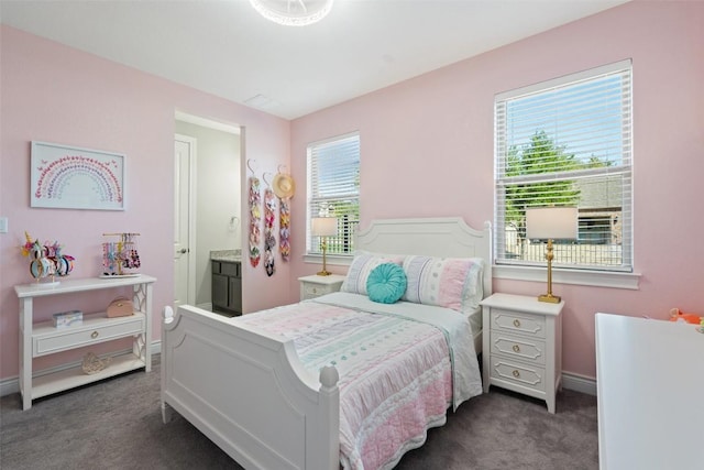 bedroom with dark colored carpet, multiple windows, and baseboards