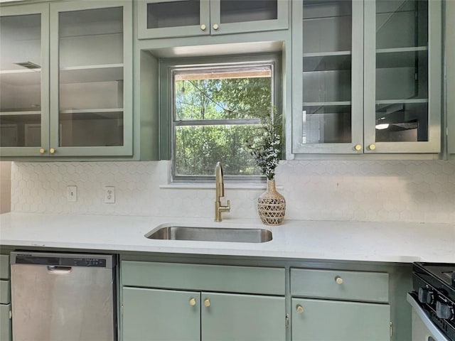 5306 Wellington Dr, Austin, TX 78723 - kitchen featuring dishwasher, a sink, green cabinets, backsplash, and light countertops