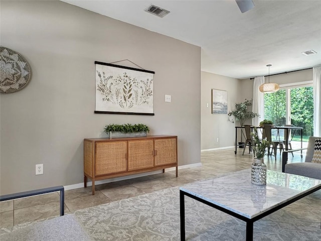 5306 Wellington Dr, Austin, TX 78723 - living room featuring baseboards and light tile patterned floors