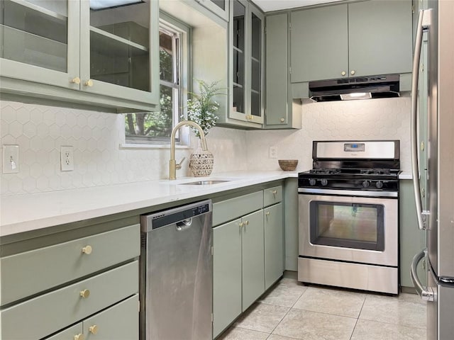 5306 Wellington Dr, Austin, TX 78723 - kitchen with appliances with stainless steel finishes, green cabinets, under cabinet range hood, and a sink