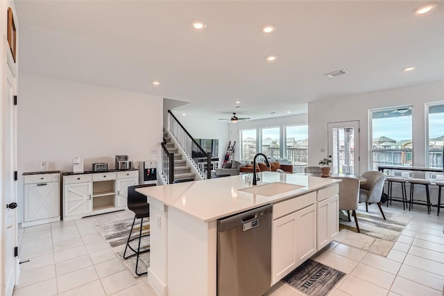 650 Texas Sage Loop, Buda, TX 78610 - kitchen with stainless steel dishwasher, light tile patterned floors, visible vents, a sink, and open floor plan
