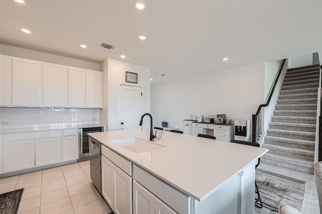 650 Texas Sage Loop, Buda, TX 78610 - kitchen with light tile patterned floors, light countertops, visible vents, stainless steel dishwasher, and a sink
