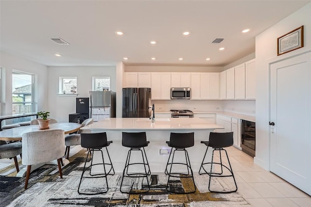 650 Texas Sage Loop, Buda, TX 78610 - kitchen featuring a center island with sink, a sink, visible vents, and stainless steel appliances