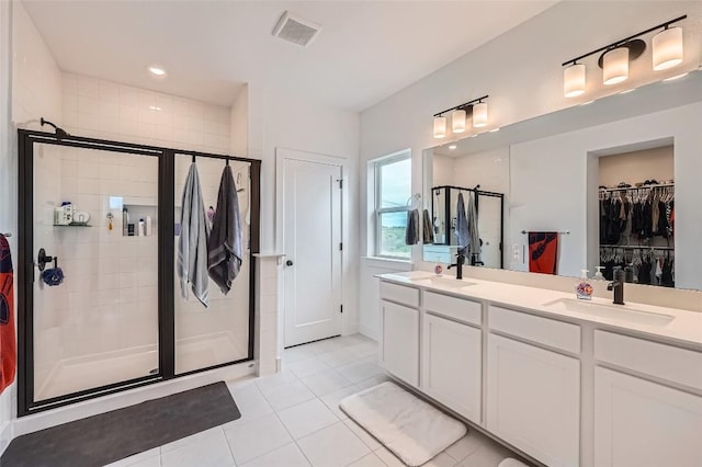 650 Texas Sage Loop, Buda, TX 78610 - bathroom with tile patterned flooring, visible vents, a sink, a stall shower, and double vanity