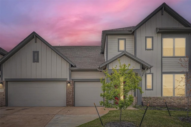 650 Texas Sage Loop, Buda, TX 78610 - view of front of property with an attached garage, board and batten siding, a shingled roof, and concrete driveway