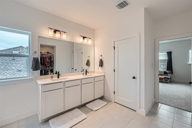 650 Texas Sage Loop, Buda, TX 78610 - ensuite bathroom featuring baseboards, double vanity, a sink, and visible vents