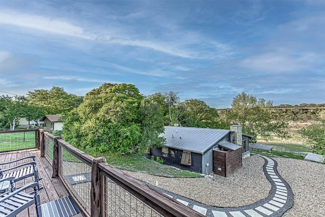 rear view of property with a wooden deck and a chimney