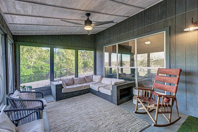 sunroom with a ceiling fan, outdoor lounge area, and lofted ceiling