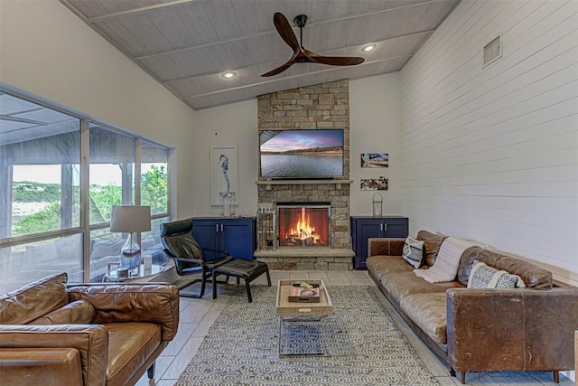 living area with vaulted ceiling, light tile patterned floors, a ceiling fan, a fireplace, and recessed lighting