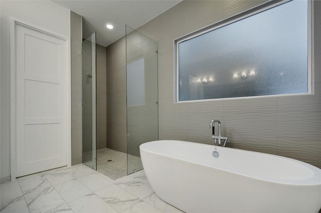 5001 Shoal Creek Blvd, Austin, TX 78756 - bathroom featuring a freestanding tub, walk in shower, tile walls, and marble finish flooring