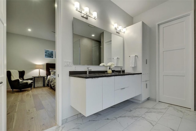 5001 Shoal Creek Blvd, Austin, TX 78756 - ensuite bathroom with double vanity, marble look tile flooring, and recessed lighting