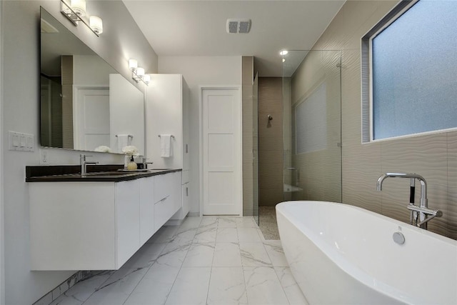 5001 Shoal Creek Blvd, Austin, TX 78756 - bathroom with marble look tile flooring, a freestanding bath, vanity, recessed lighting, and a shower