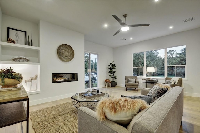 5001 Shoal Creek Blvd, Austin, TX 78756 - living area with ceiling fan, wood finished floors, a glass covered fireplace, and recessed lighting