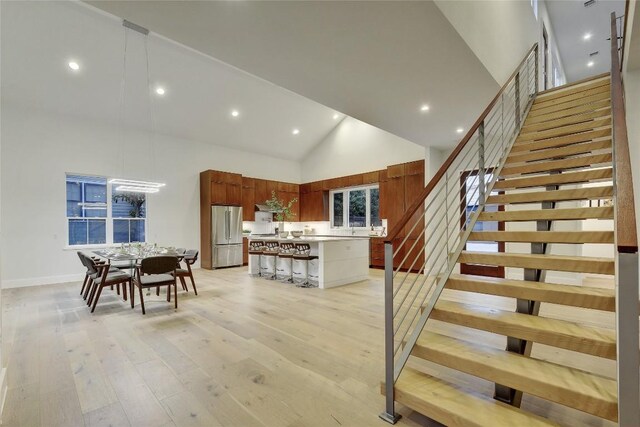 5001 Shoal Creek Blvd, Austin, TX 78756 - staircase featuring high vaulted ceiling, wood-type flooring, and recessed lighting