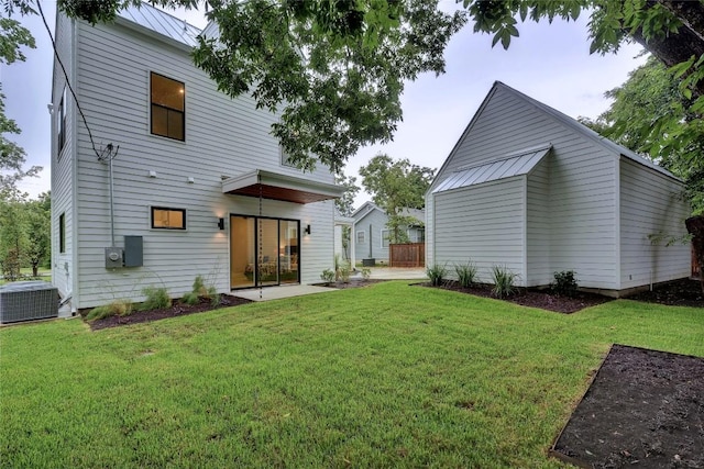 5001 Shoal Creek Blvd, Austin, TX 78756 - rear view of property with a lawn, a metal roof, and a patio area