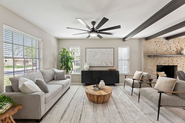 8014 Stillwood Ln, Austin, TX 78757 - living room featuring a ceiling fan, a stone fireplace, beamed ceiling, and wood finished floors