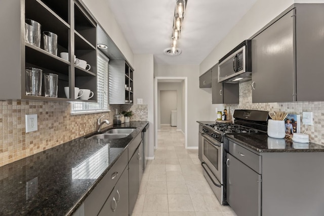 8014 Stillwood Ln, Austin, TX 78757 - kitchen featuring appliances with stainless steel finishes, open shelves, backsplash, and gray cabinetry
