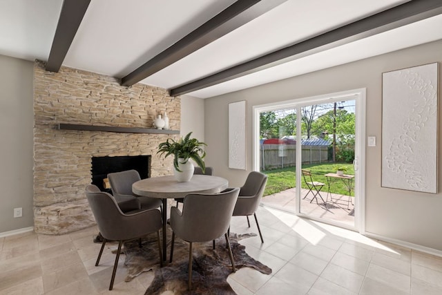 8014 Stillwood Ln, Austin, TX 78757 - dining area featuring beamed ceiling, light tile patterned floors, and a fireplace