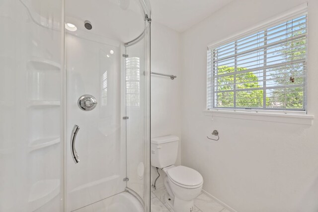8014 Stillwood Ln, Austin, TX 78757 - bathroom featuring baseboards, a stall shower, and toilet