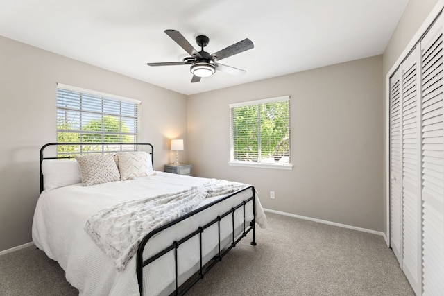 8014 Stillwood Ln, Austin, TX 78757 - carpeted bedroom featuring multiple windows, a closet, and ceiling fan