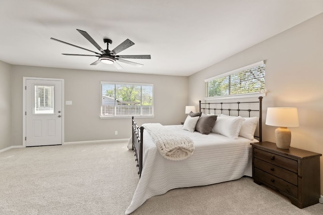 8014 Stillwood Ln, Austin, TX 78757 - bedroom featuring a ceiling fan, baseboards, light carpet, and multiple windows