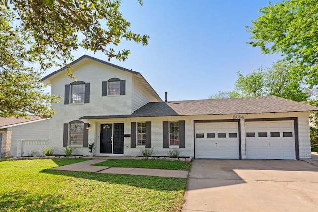 8014 Stillwood Ln, Austin, TX 78757 - traditional-style house featuring brick siding, a garage, concrete driveway, and a front yard