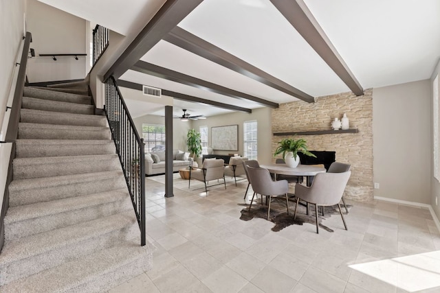 8014 Stillwood Ln, Austin, TX 78757 - dining room with stairway, beam ceiling, ceiling fan, a stone fireplace, and light tile patterned floors