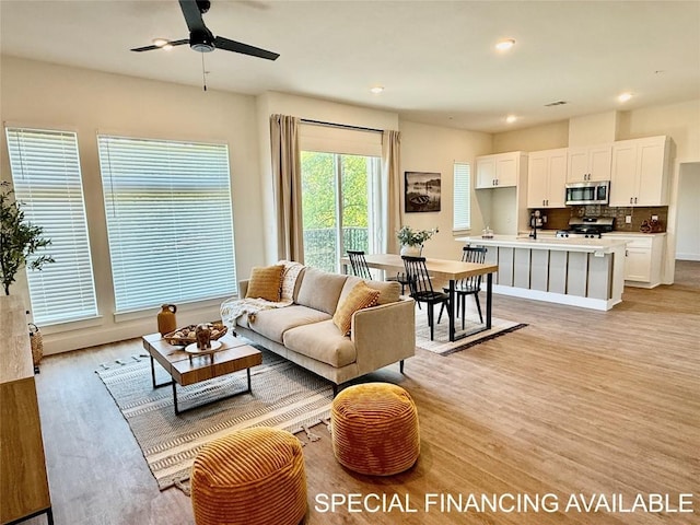 1811 Webberville Rd Unit 1206, Austin, TX 78721 - living room featuring light wood finished floors, ceiling fan, and recessed lighting