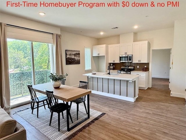 1811 Webberville Rd Unit 1206, Austin, TX 78721 - dining area featuring wood finished floors, baseboards, and recessed lighting